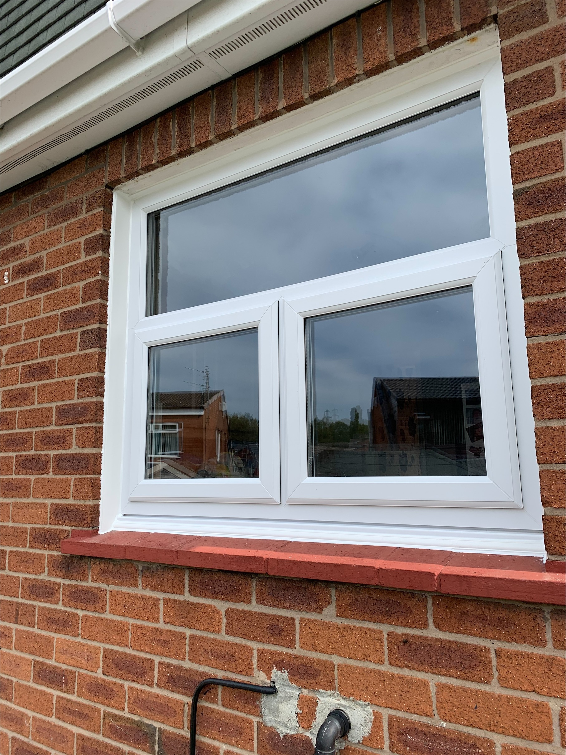White UPVC casement windows on brick house